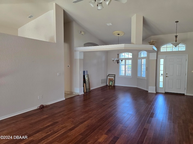 entrance foyer featuring high vaulted ceiling, dark wood-type flooring, and ceiling fan with notable chandelier