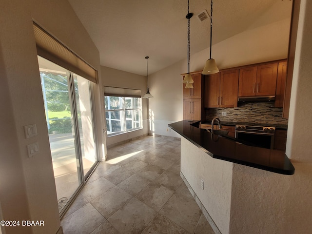 kitchen with sink, tasteful backsplash, oven, pendant lighting, and vaulted ceiling