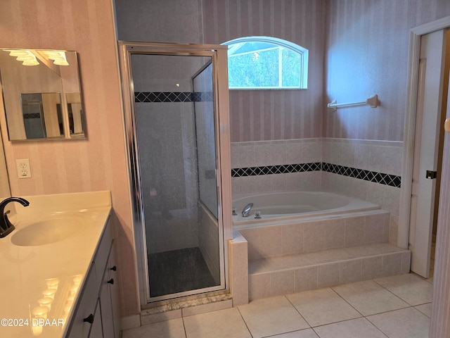 bathroom with tile patterned floors, vanity, and independent shower and bath