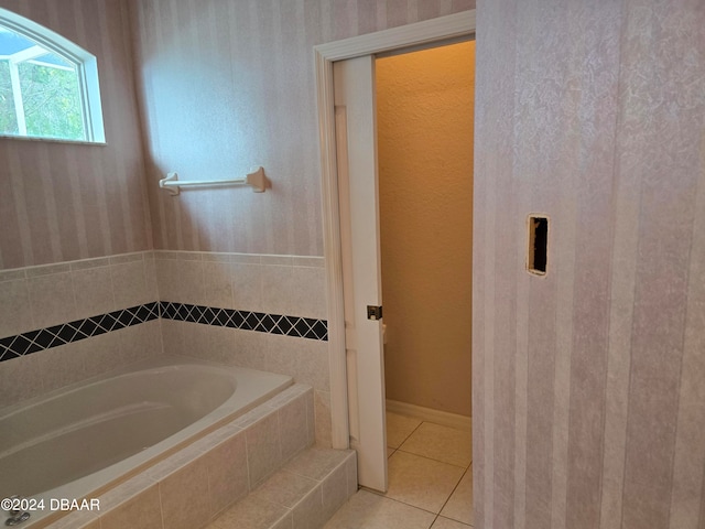 bathroom with tile patterned floors and tiled tub