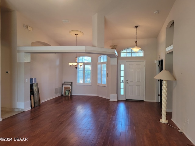 entryway featuring dark hardwood / wood-style flooring, high vaulted ceiling, and a chandelier