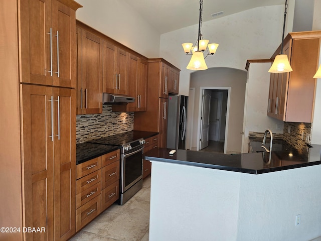 kitchen with decorative backsplash, stainless steel appliances, and decorative light fixtures