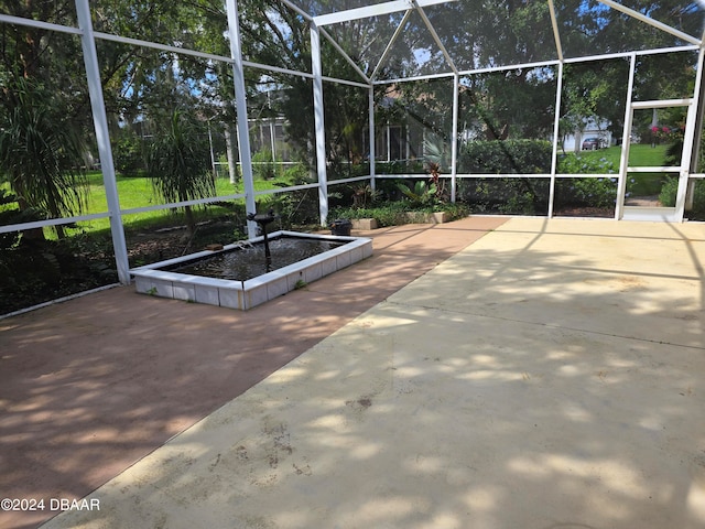 view of patio / terrace featuring glass enclosure