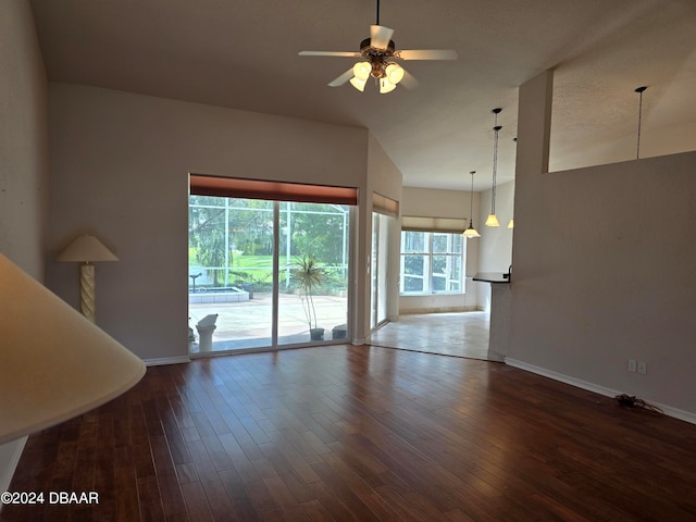 unfurnished living room with hardwood / wood-style floors, a wealth of natural light, and ceiling fan