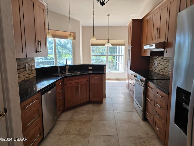 kitchen featuring decorative backsplash, range hood, sink, and appliances with stainless steel finishes