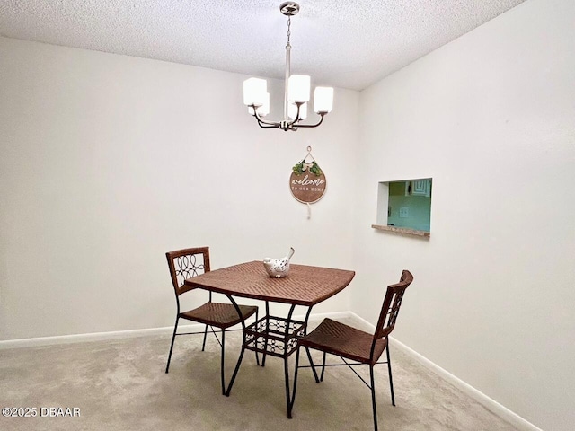 carpeted dining space featuring a textured ceiling and an inviting chandelier