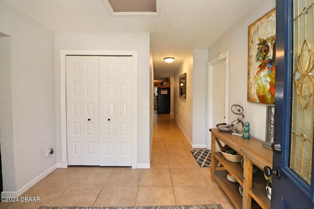 hall with light tile patterned flooring