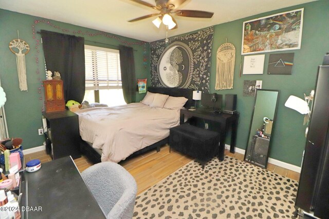 bedroom with wood-type flooring and ceiling fan