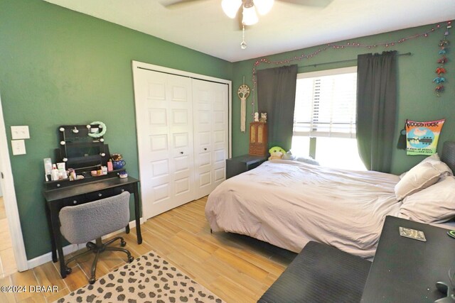 bedroom featuring wood-type flooring, ceiling fan, and a closet