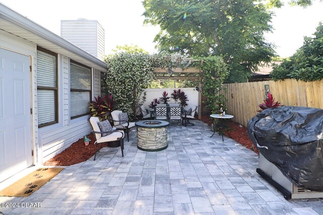 view of patio featuring area for grilling and a fire pit