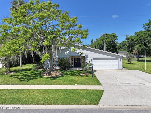 view of front of home featuring a garage and a front lawn