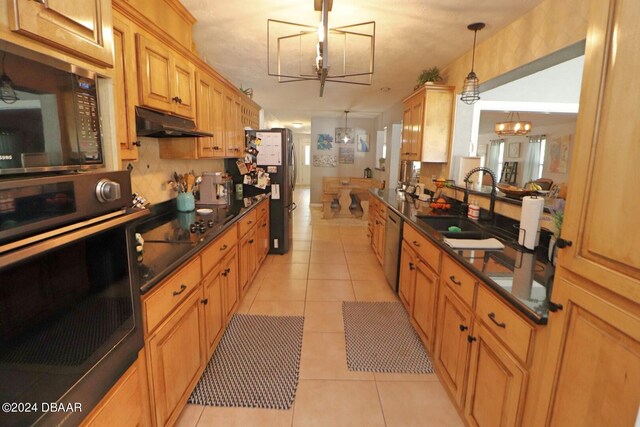 kitchen with sink, black appliances, light tile patterned floors, an inviting chandelier, and pendant lighting