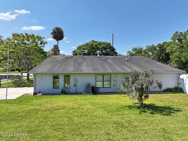 rear view of house with a lawn