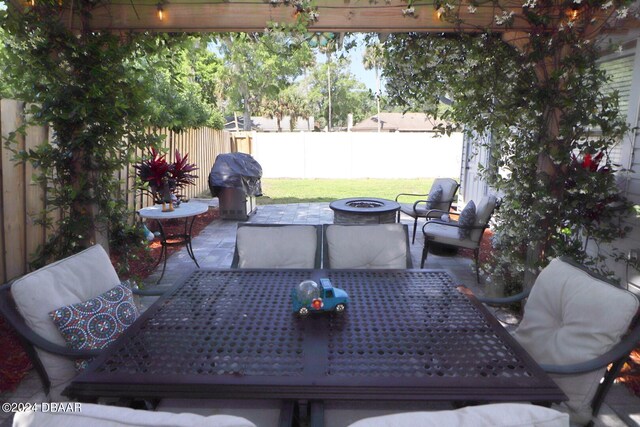 view of patio with a grill and a fire pit