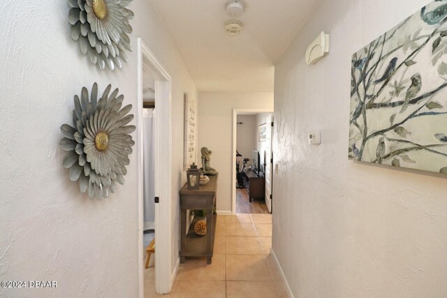 hall with light tile patterned flooring