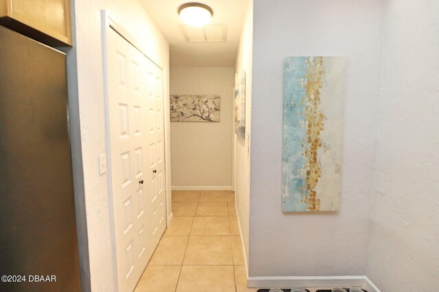 hall with light tile patterned flooring