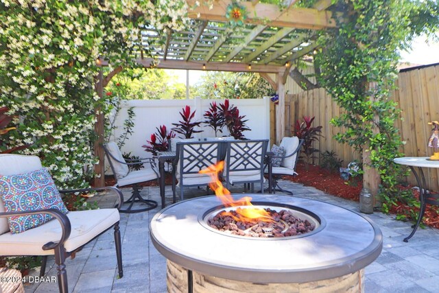 view of patio featuring a pergola and an outdoor fire pit