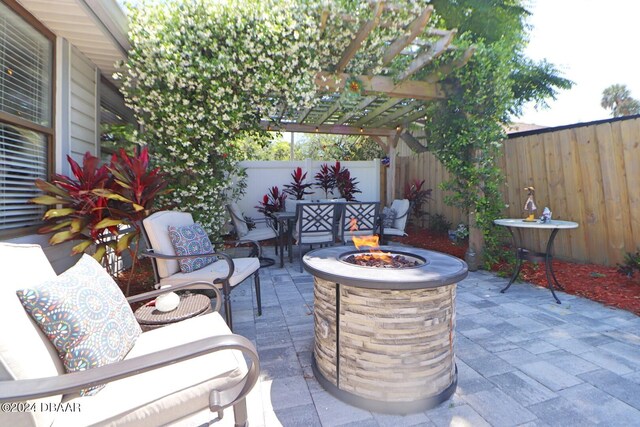 view of patio / terrace with a pergola and an outdoor fire pit