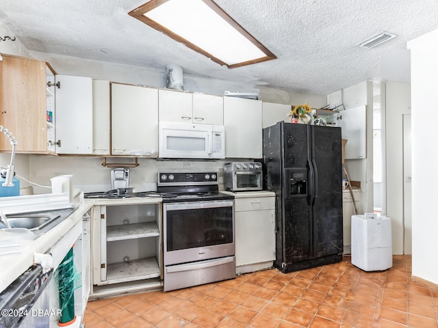 kitchen featuring white cabinets, black fridge, a textured ceiling, and stainless steel electric stove