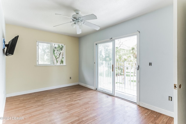 spare room with light hardwood / wood-style flooring, a healthy amount of sunlight, and ceiling fan