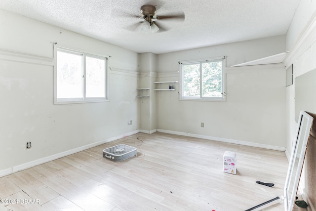 unfurnished bedroom featuring a textured ceiling, light hardwood / wood-style floors, and ceiling fan