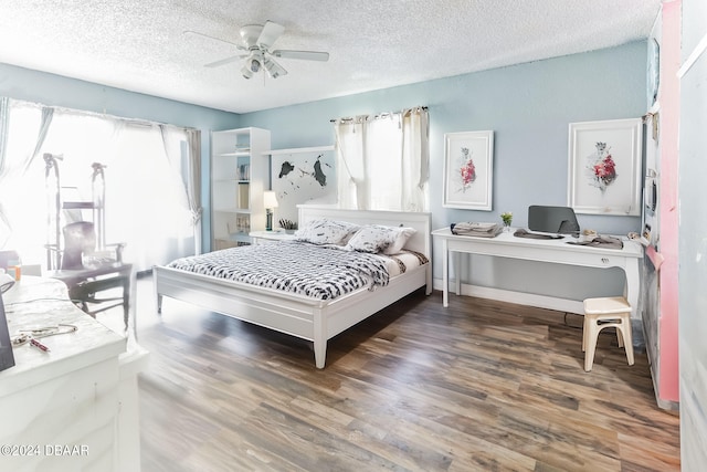 bedroom with a textured ceiling, dark hardwood / wood-style floors, and ceiling fan