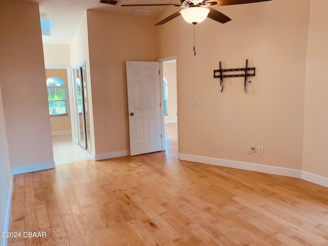 unfurnished room with high vaulted ceiling, light hardwood / wood-style flooring, and ceiling fan