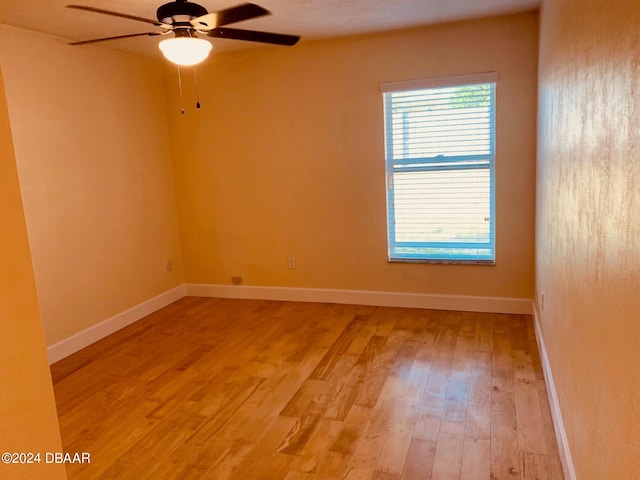 spare room featuring ceiling fan and light hardwood / wood-style flooring