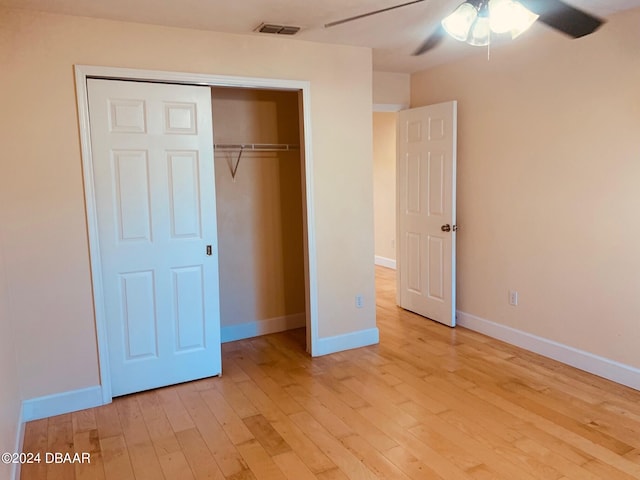 unfurnished bedroom with a closet, light wood-type flooring, and ceiling fan