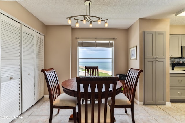 1183 Ocean Shore Blvd Unit 5050, Ormond Beach, FL 32176 - dining space featuring light tile patterned floors, a textured ceiling, and baseboards