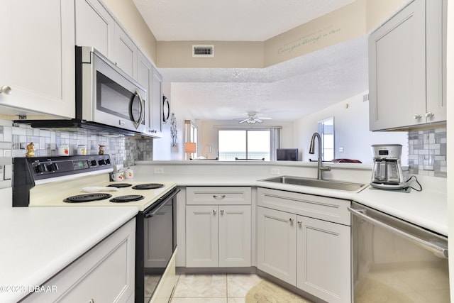 1183 Ocean Shore Blvd Unit 5050, Ormond Beach, FL 32176 - kitchen with appliances with stainless steel finishes, a sink, light countertops, backsplash, and a textured ceiling