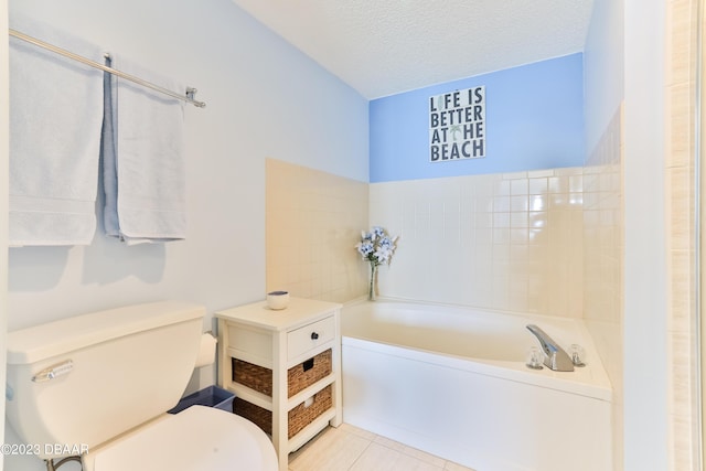 1183 Ocean Shore Blvd Unit 5050, Ormond Beach, FL 32176 - full bath featuring a garden tub, a textured ceiling, tile patterned flooring, and toilet