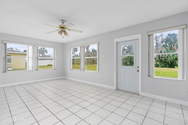 unfurnished sunroom featuring a wealth of natural light and ceiling fan