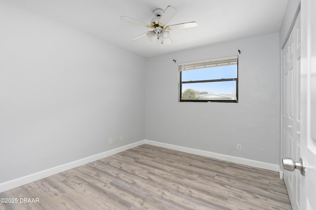 empty room with ceiling fan and light wood-type flooring