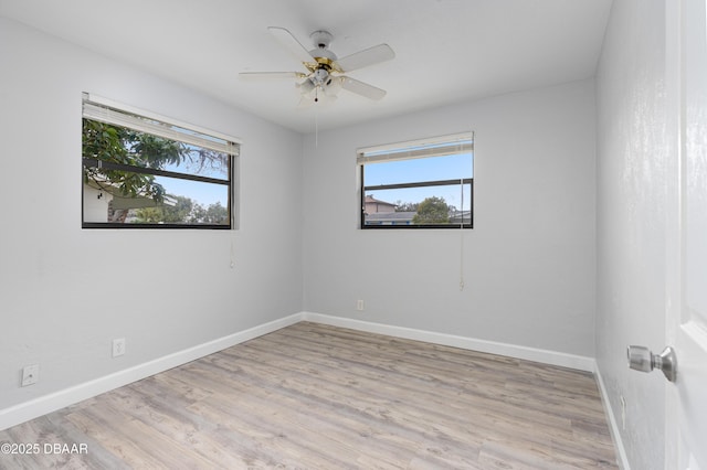 empty room with light hardwood / wood-style flooring and ceiling fan