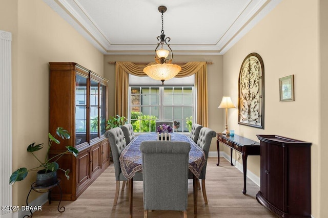 3428 Rexford Cir, Ormond Beach, FL 32174 - dining area with light wood-type flooring, crown molding, and baseboards