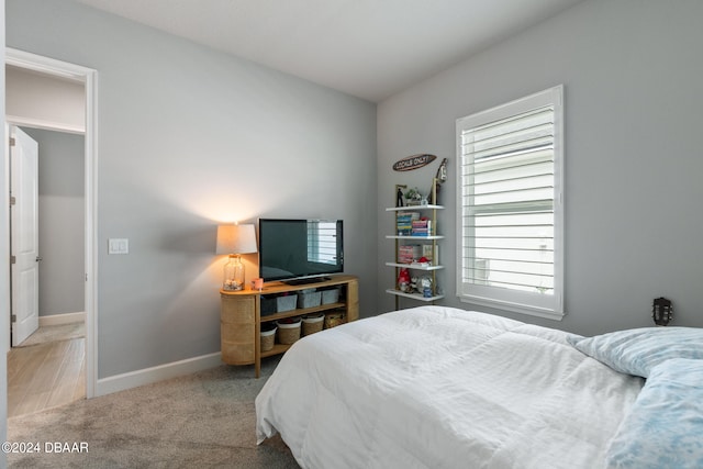 bedroom featuring light carpet