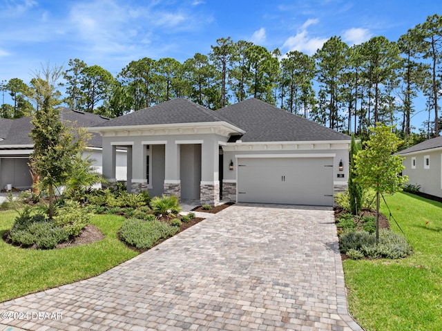 view of front of property featuring a front lawn and a garage