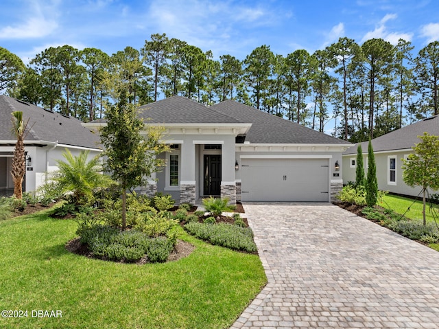 view of front of house featuring a garage and a front yard