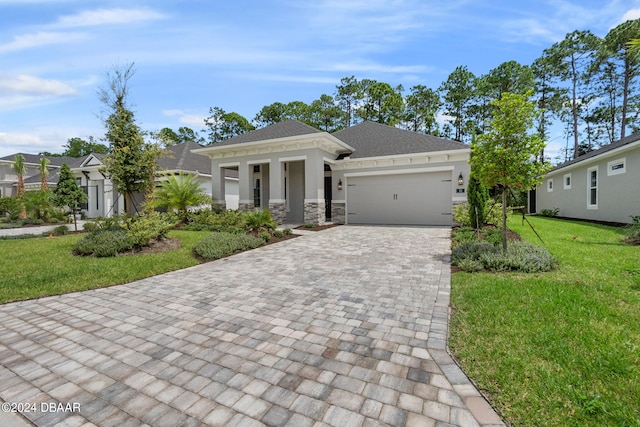 view of front of house with a garage and a front lawn