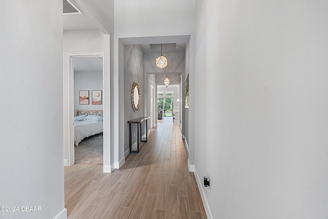 hall with hardwood / wood-style floors