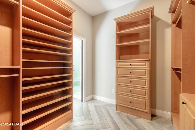 walk in closet featuring light parquet flooring