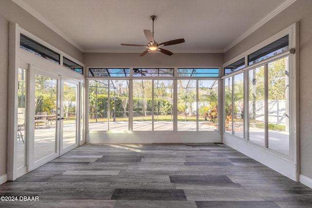 unfurnished sunroom featuring ceiling fan and a healthy amount of sunlight