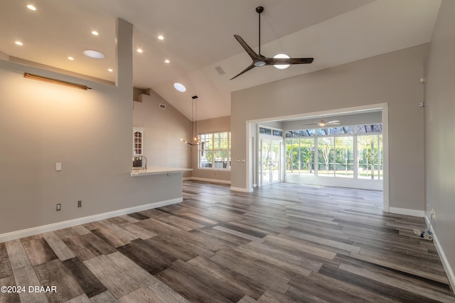 unfurnished living room featuring ceiling fan, wood-type flooring, and high vaulted ceiling