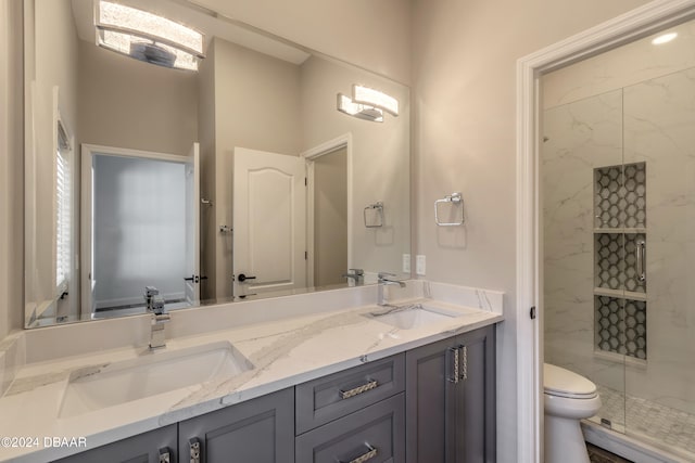 bathroom featuring an enclosed shower, vanity, and toilet