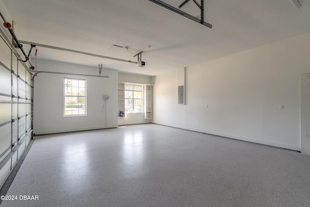 garage featuring a garage door opener and electric panel