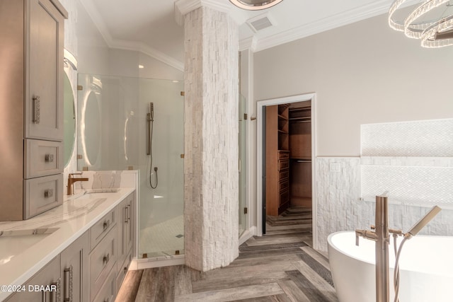 bathroom featuring ornamental molding, vanity, hardwood / wood-style flooring, and plus walk in shower