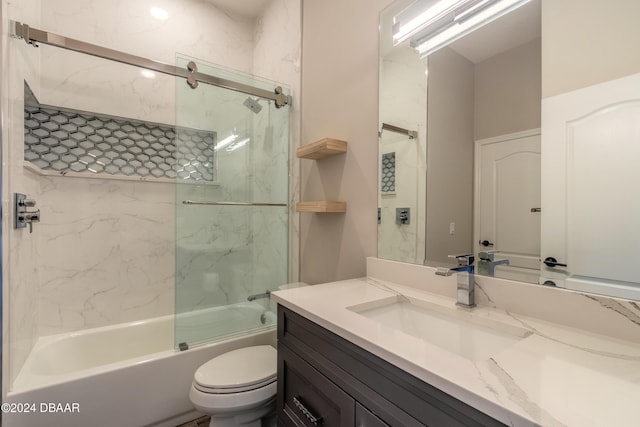 full bathroom with shower / bath combination with glass door, vanity, and toilet