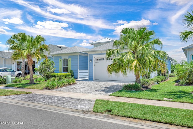 464 Tropics Ave, Daytona Beach, FL 32124 - view of front of property with an attached garage, decorative driveway, a front yard, and roof with shingles