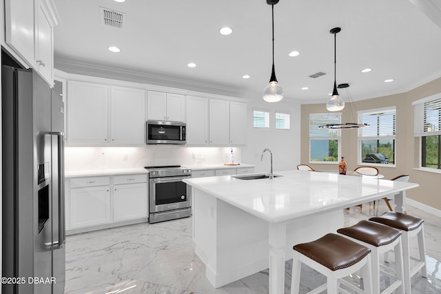 464 Tropics Ave, Daytona Beach, FL 32124 - kitchen with appliances with stainless steel finishes, a sink, light marble finish flooring, a breakfast bar, and white cabinetry